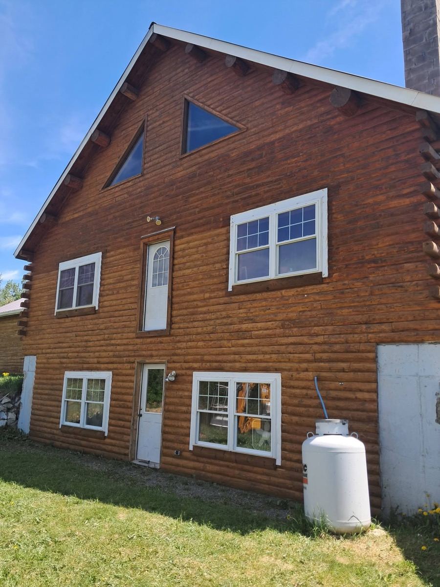 Log home fully restained to a rich brown by Freedom Painting
