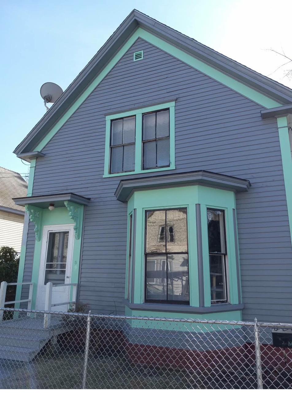 Blue and green painted house after