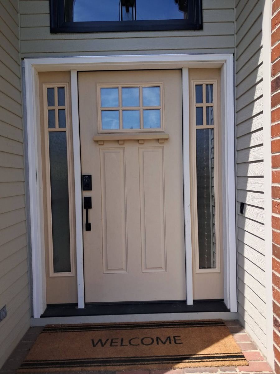Beige craftsman front door with sidelights before repaint