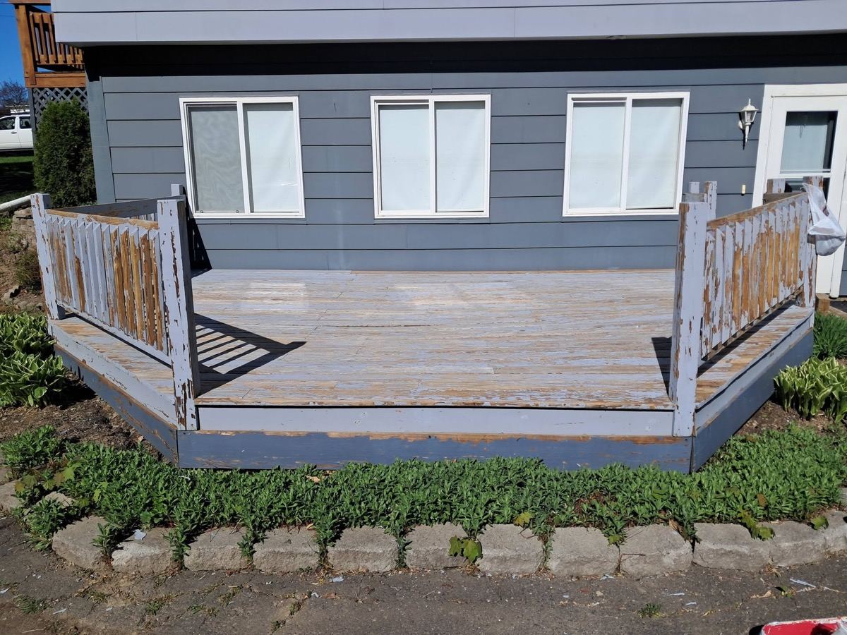 Weathered grey deck with peeling paint before restoration